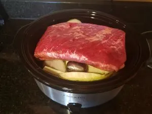 corned beef laid over cabbage and onion