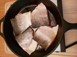 Blackened Salmon raw in skillet